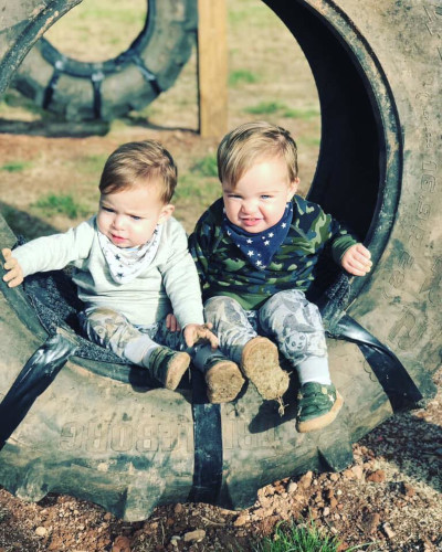 Human twins playing in the tyres